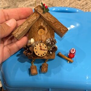 Christmas ornament depicting a wooden bird house clock
